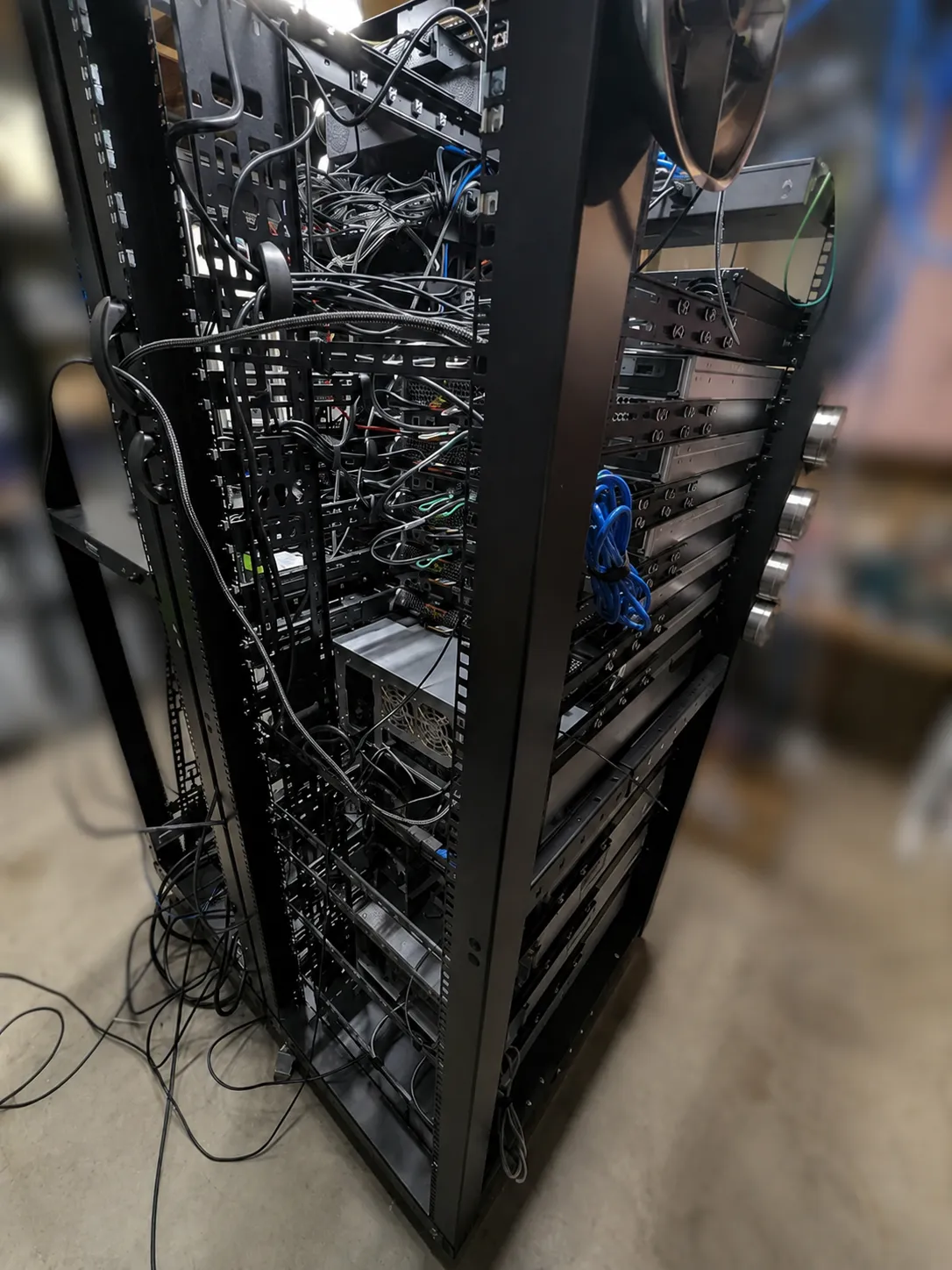 Rear view of Julien's basement server rack and homelab cabling